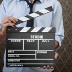 Businessman with clapperboard