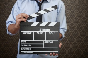 Businessman with clapperboard