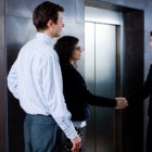 Business greeting at elevator